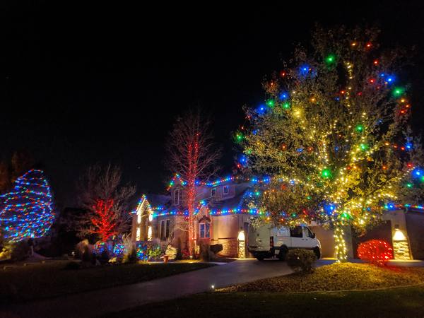 Multicolor lights on trees and roofline